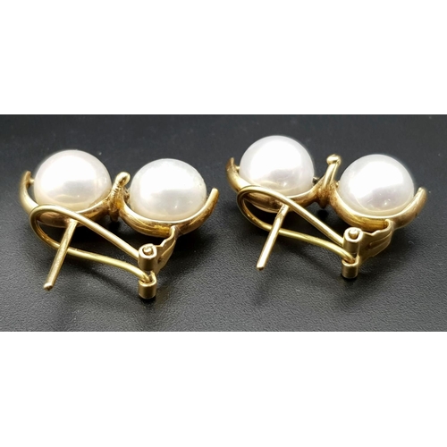 246 - A Pair of 18K Yellow Gold Twin South Sea Pearl Earrings. Clip design. 10mm pearls. 9g total weight.