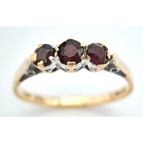 254 - A Vintage 9K Yellow Gold Garnet Gemstone Trilogy Ring. Size M 1/2. 1.5g total weight.