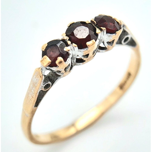 254 - A Vintage 9K Yellow Gold Garnet Gemstone Trilogy Ring. Size M 1/2. 1.5g total weight.