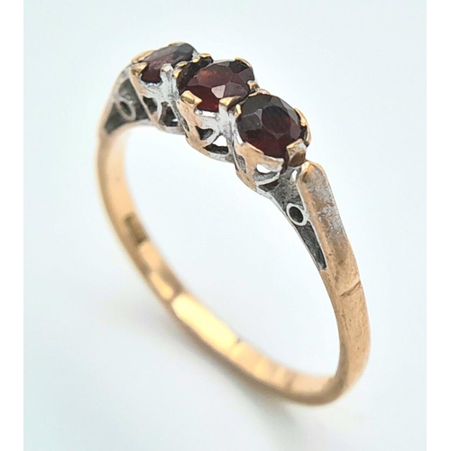 254 - A Vintage 9K Yellow Gold Garnet Gemstone Trilogy Ring. Size M 1/2. 1.5g total weight.