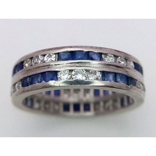 323 - A Stylish 18K White Gold Diamond and Sapphire Full Eternity 
Two Row Ring. Alternating three diamond... 