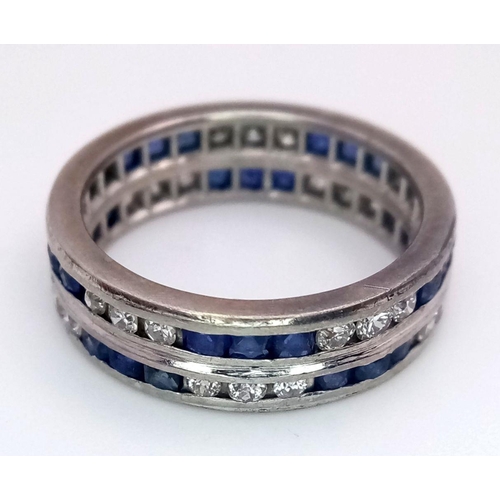 323 - A Stylish 18K White Gold Diamond and Sapphire Full Eternity 
Two Row Ring. Alternating three diamond... 