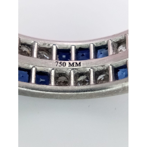 323 - A Stylish 18K White Gold Diamond and Sapphire Full Eternity 
Two Row Ring. Alternating three diamond... 