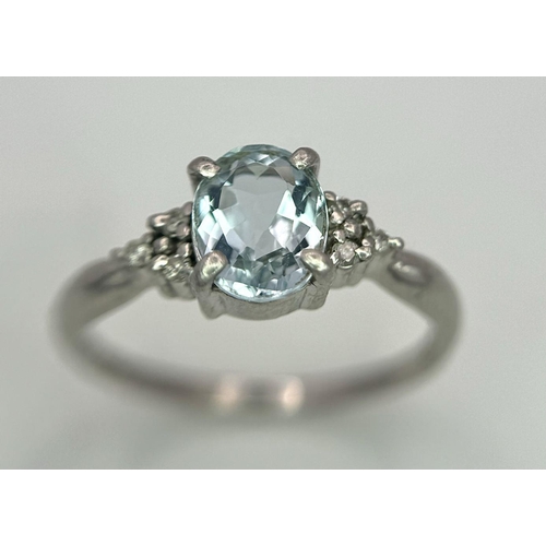 330 - A Vintage 900 Platinum Blue Topaz and Diamond Ring. Oval cut 1ct topaz with diamond accents. Size O.... 