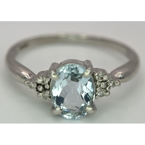 330 - A Vintage 900 Platinum Blue Topaz and Diamond Ring. Oval cut 1ct topaz with diamond accents. Size O.... 