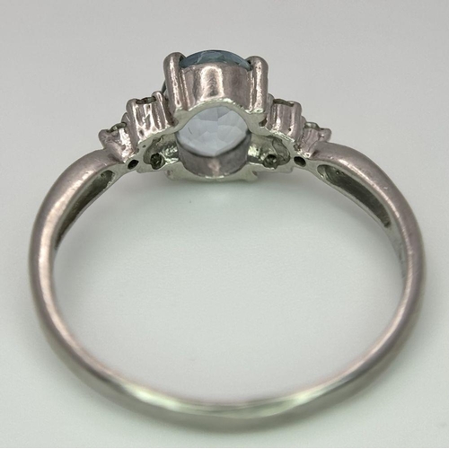 330 - A Vintage 900 Platinum Blue Topaz and Diamond Ring. Oval cut 1ct topaz with diamond accents. Size O.... 