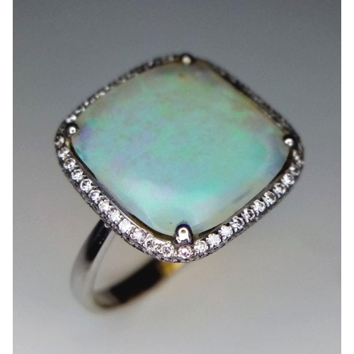 337 - An 18K White Gold Opal and Diamond Ring. Square cut translucent opal with excellent colour-play and ... 