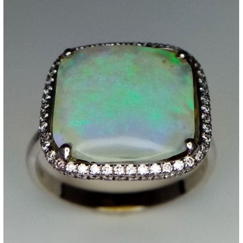 337 - An 18K White Gold Opal and Diamond Ring. Square cut translucent opal with excellent colour-play and ... 