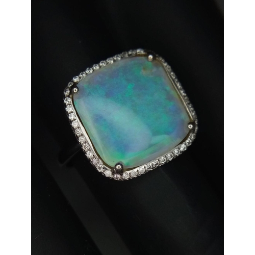 337 - An 18K White Gold Opal and Diamond Ring. Square cut translucent opal with excellent colour-play and ... 