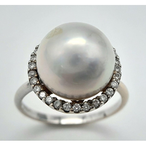 421 - An 18K White Gold South Sea Pearl and Diamond Ring. A South Sea Pearl Cabochon with diamond halo. Si... 