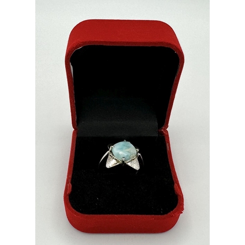 449 - A Turquoise Cabochon 925 Silver Floral Ring. Size O. Weight - 6.6g. HV2303