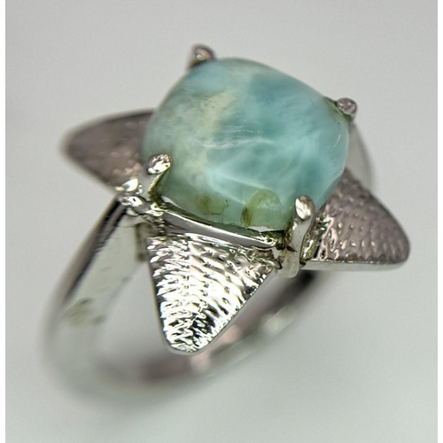 449 - A Turquoise Cabochon 925 Silver Floral Ring. Size O. Weight - 6.6g. HV2303