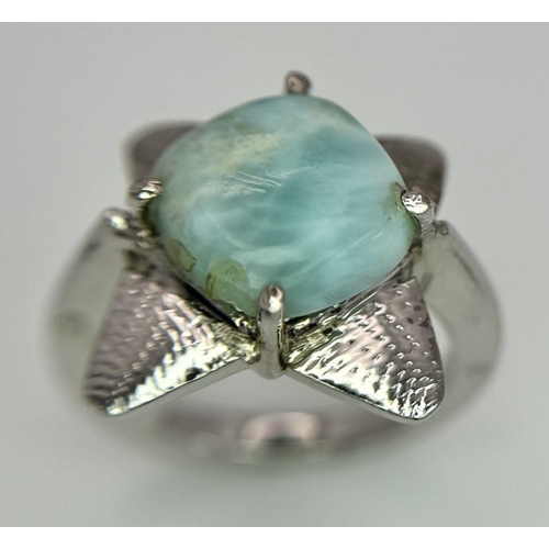 449 - A Turquoise Cabochon 925 Silver Floral Ring. Size O. Weight - 6.6g. HV2303