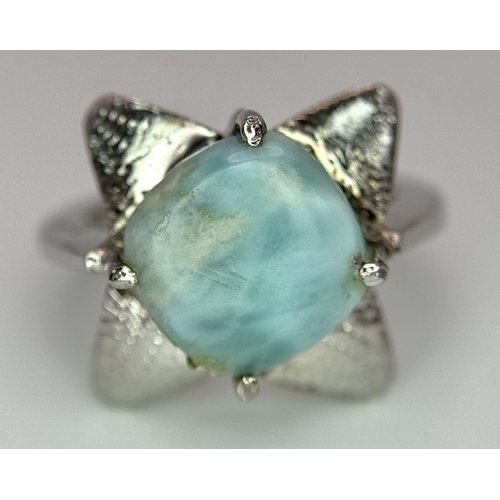 449 - A Turquoise Cabochon 925 Silver Floral Ring. Size O. Weight - 6.6g. HV2303