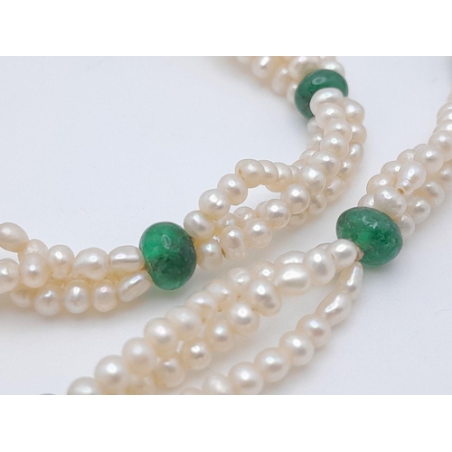 498 - A Three Row Seed Pearl Necklace with Emerald Spacers. 40cm.