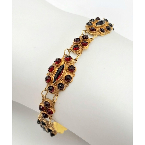 533 - A Vintage 18K Yellow Gold Garnet Bracelet. Rich links of round and marquise cut garnets. 16cm. safet... 