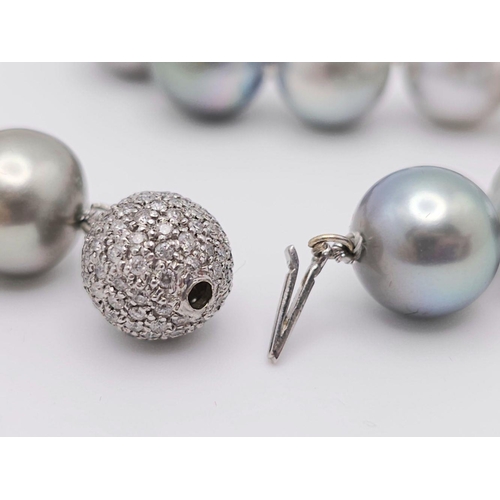 99 - A Mesmerising Tahitian Pearl Necklace. Different shades of greys and silvers. Diamond encrusted glit... 