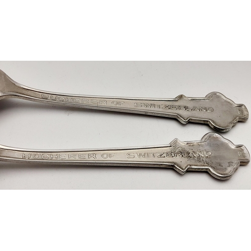 1417 - A pair of small metal teaspoons made for Bucherer of Lucerne Switzerland. 11cm in length. See photos... 
