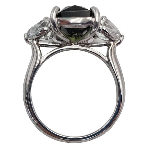 479 - An 18K White Gold Tourmaline and White Topaz Ring. A 5ct rectangular rich green tourmaline with a 0.... 