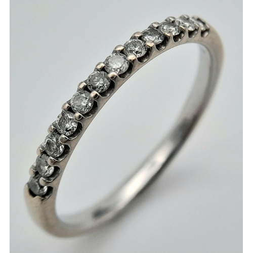 1354 - An 18K White Gold and Diamond Half Eternity Ring. Size P. 2.4g total weight. Ref: 017640