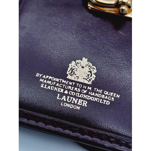 1404 - A Launer Burgundy Wallet. Leather exterior, gold-tone metal clasp that open to reveal six card slots... 
