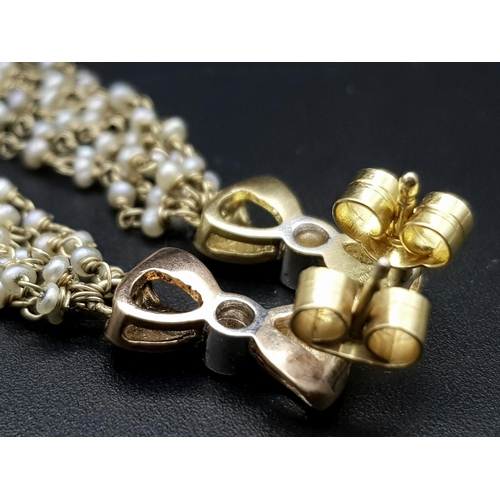 106 - A pair of Vintage 18K Yellow Gold Tahitian Pearl and Diamond Drop Earrings. Six strands of petit pea... 