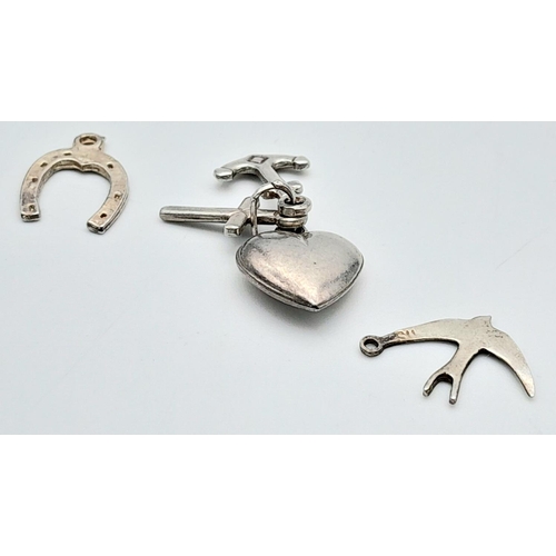 1374 - Three Silver Charms - lucky horseshoe, swallow, and faith, hope and love.