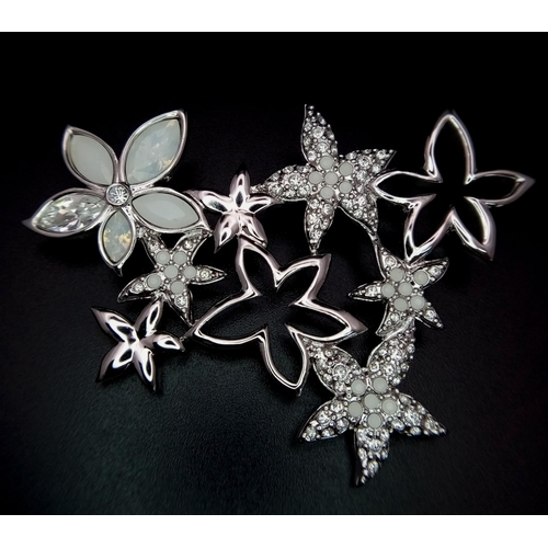 1403 - A new Swarovski silver tone star flower brooch, 6 x 4.5cm, Comes with original packaging and certifi... 