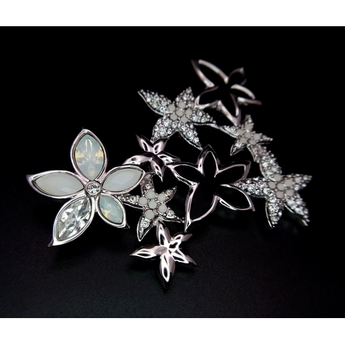 1403 - A new Swarovski silver tone star flower brooch, 6 x 4.5cm, Comes with original packaging and certifi... 