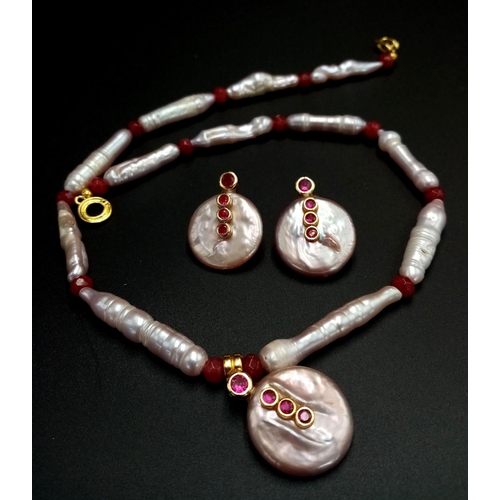 157 - A fine, large elongate pearls with round flat pearl accents and adorned with rubies necklace and ear... 