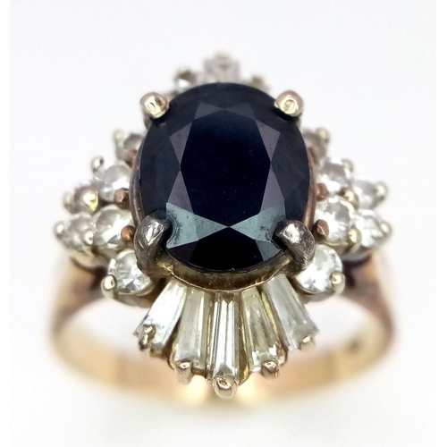 163 - A Vintage 14K Yellow Gold Sapphire and Diamond Ring. Central oval sapphire with a brilliant round an... 