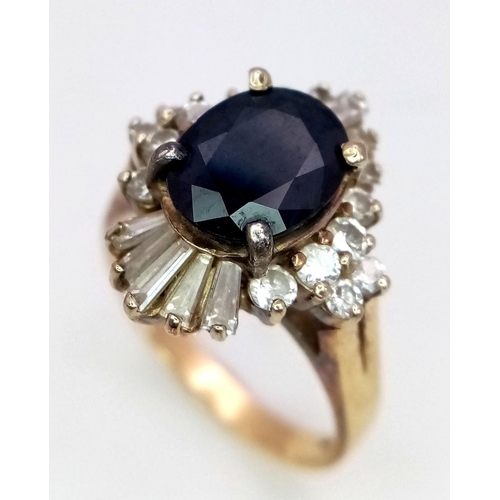 163 - A Vintage 14K Yellow Gold Sapphire and Diamond Ring. Central oval sapphire with a brilliant round an... 