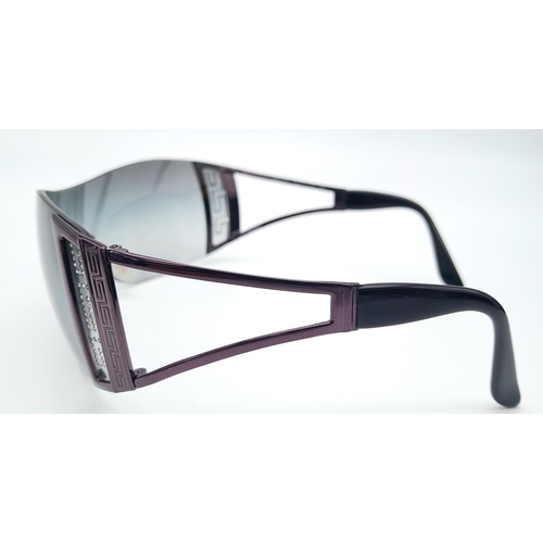 164 - A GIANNI VERSACE ladies’ sunglasses, panoramic single viewing lens in smoky quartz colour, Greek key... 