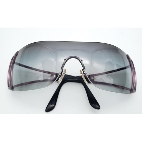 164 - A GIANNI VERSACE ladies’ sunglasses, panoramic single viewing lens in smoky quartz colour, Greek key... 