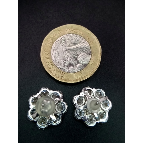 170 - A Stunning Pair of 900 Platinum Diamond Earrings. 5.74ctw of brilliant round cut VS2 diamonds in flo... 