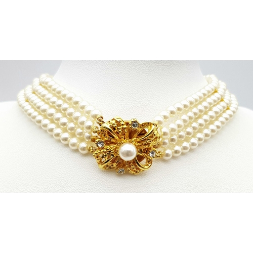 178 - A vintage PIERRE CARDIN four strand simulated pearl choker necklace with a glamorous gold-plated cla... 