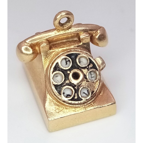 211 - A 14K Yellow Gold Dial Telephone Pendant/Charm. 4g weight. 15mm