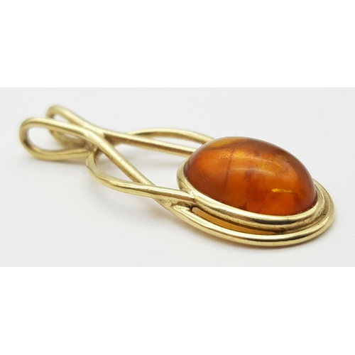 24 - A 9K Yellow Gold Amber Cabochon Pendant. 4cm. 3.5g total weight.