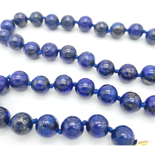 241 - A Lapis Lazuli Beaded Necklace with a Hanging Baroque Pearl Pendant. Gilded clasp with white stone a... 