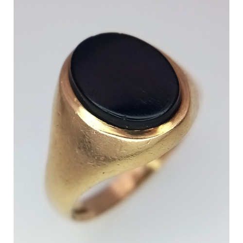 289 - A 9K Yellow Gold Black Onyx Signet Ring. Size K. 2.2g total weight.