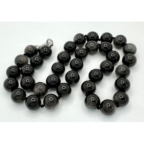 442 - A 'Silver Eye' Black Obsidian Beaded Necklace. 12mm beads.
48cm necklace length.