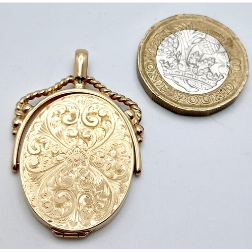 8 - A 9K yellow Gold Spinning Locket Fob Style Pendant. Engraved decoration. 4cm. 8.2g total weight.