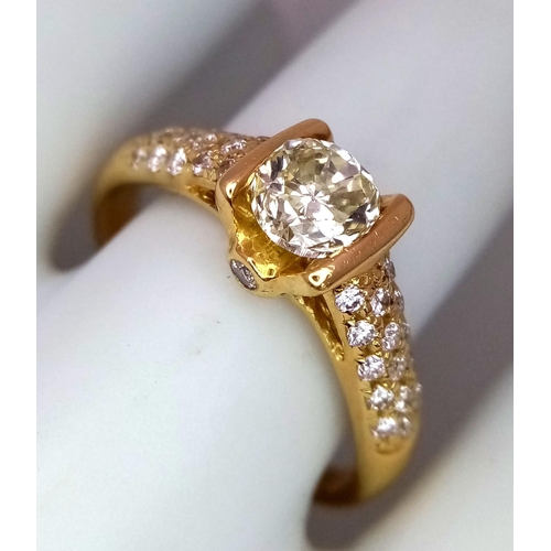 92 - An 18K Yellow Gold and Diamond Gents Dress Ring. A 1.044ct brilliant round cut centre diamond is acc... 