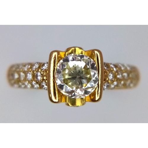 92 - An 18K Yellow Gold and Diamond Gents Dress Ring. A 1.044ct brilliant round cut centre diamond is acc... 