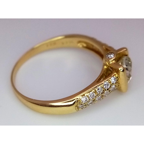 92 - An 18K Yellow Gold and Diamond Gents Dress Ring. A 1.044ct brilliant round cut centre diamond is acc... 