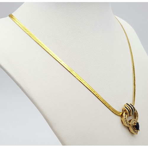 52 - An 18K Yellow Gold Sapphire and Diamond Pendant on a 14K Yellow Gold Herringbone Necklace. A teardro... 