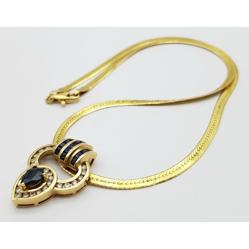 52 - An 18K Yellow Gold Sapphire and Diamond Pendant on a 14K Yellow Gold Herringbone Necklace. A teardro... 