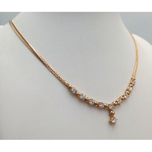 57 - A Gorgeous 18K Yellow Gold Diamond Necklace - Herringbone form leads to 10 brilliant round cut diamo... 