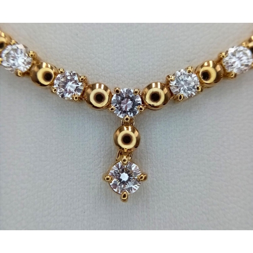 57 - A Gorgeous 18K Yellow Gold Diamond Necklace - Herringbone form leads to 10 brilliant round cut diamo... 