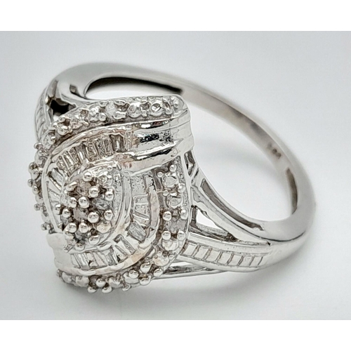 669 - An Art Deco Design Sterling Silver Diamond Set Cluster Ring Size O. Crown Measures 1.6cm length. Set... 